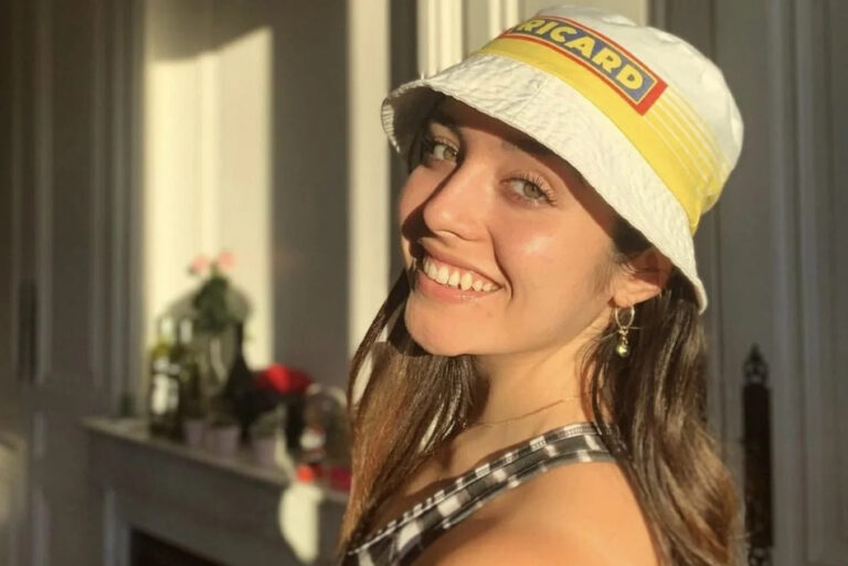 Une jeune fille du sud souriante et bronzée porte un bob ricard authentique sur sa tête