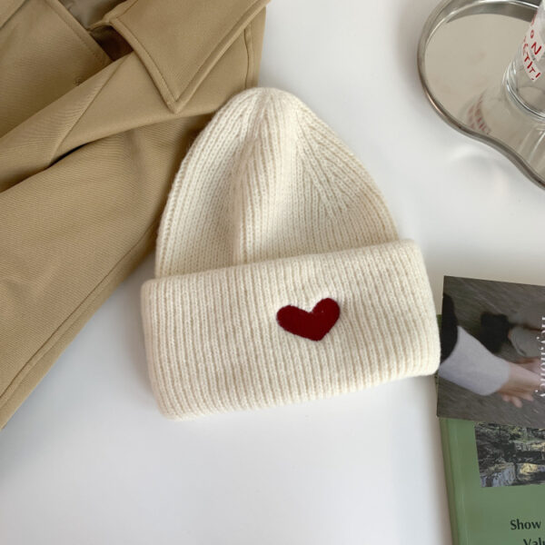 bonnet-cœur-blanc Un bonnet cœur couleur blanc est présenté posé à plat