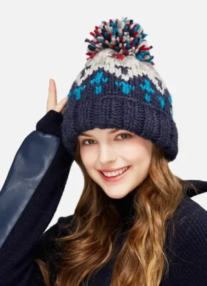 bonnet-laine-chaud-hiver-avec-pompon-pour-femme Une femme porte un bonnet avec pompon chaud