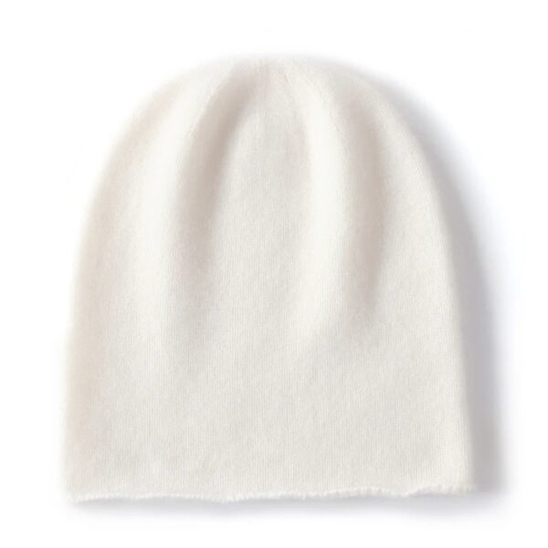 Un bonnet en cachemire de couleur blanche est présenté à plat sur un fond blanc