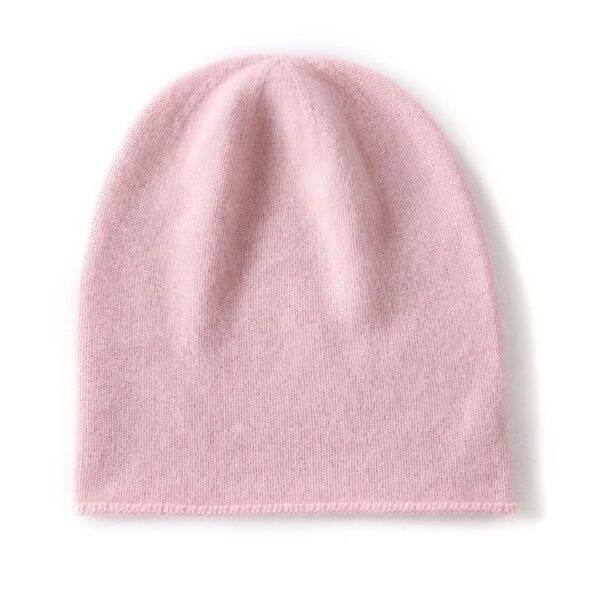 Un bonnet en cachemire de couleur rose est présenté à plat sur un fond blanc